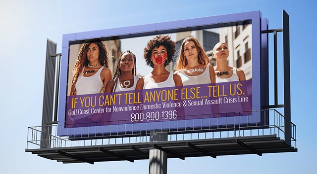 GCCFN billboard showing strong women in white tee shirts reading if you can't tell anyone else tell us
